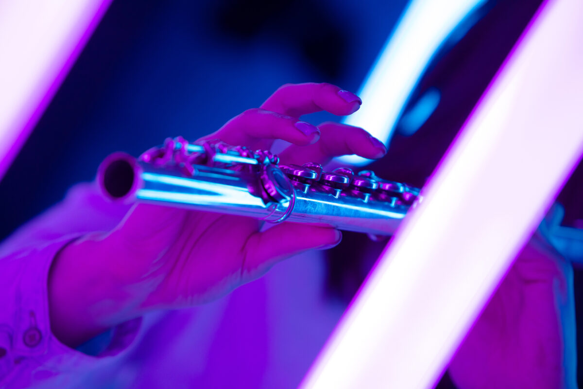 close up of female hands playing jazz flute